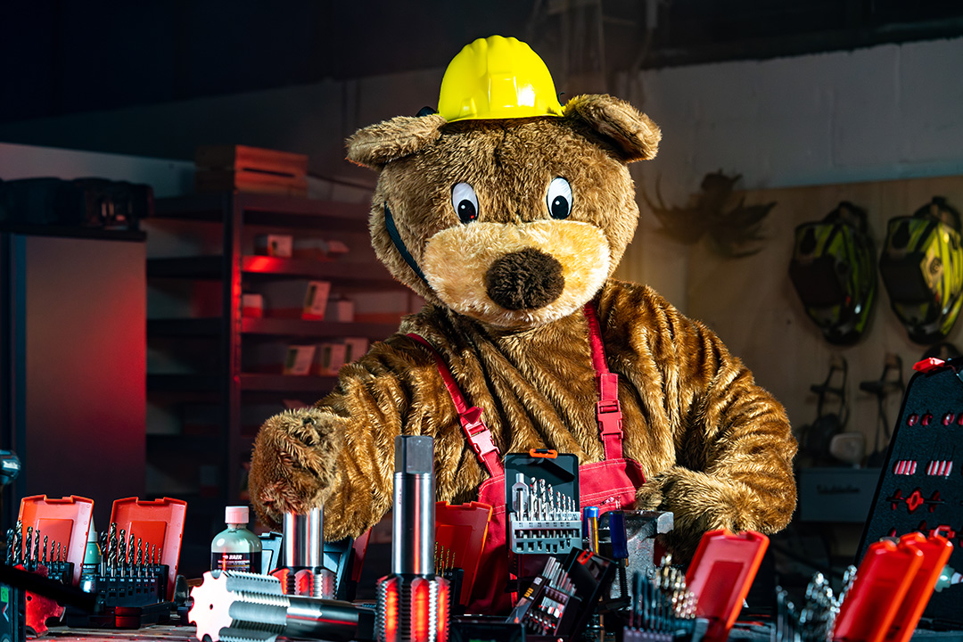 Bernd the bear with various threading tools